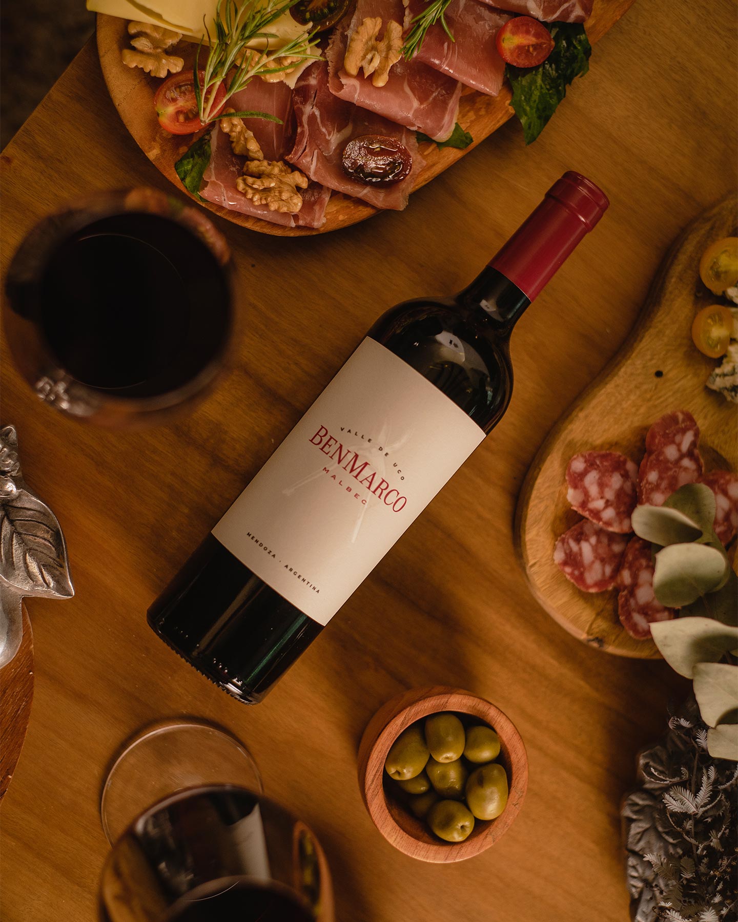 BenMarco Malbec 2022 bottle on table with food